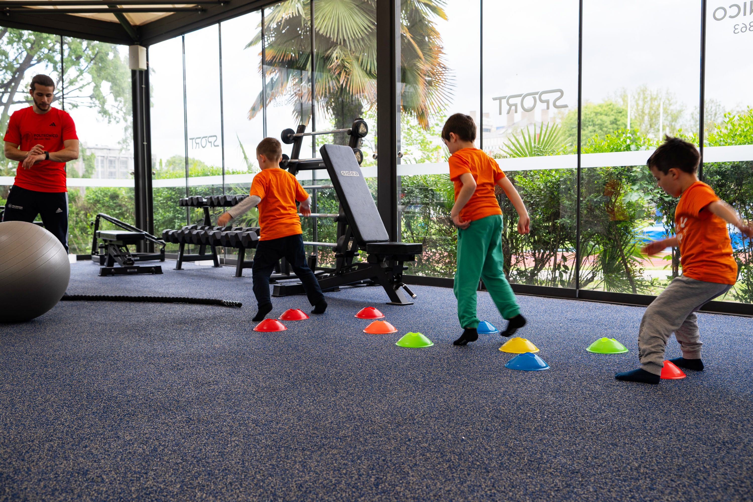 Children jumping obstacles in sport room